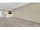 Open-concept living room with ceiling fan and neutral tones that lead into the kitchen at 417 Enclave Pl # 2, Lakeland, FL 33803