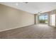 Spacious living room with plush carpet, sliding glass doors, and a ceiling fan at 417 Enclave Pl # 2, Lakeland, FL 33803