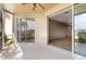 Wide patio with ceiling fan and a view of golf course through the screened-in portion at 417 Enclave Pl # 2, Lakeland, FL 33803