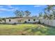 Wide view of the home's backyard featuring a deck, patio, and lush lawn at 4601 Sw Reynosa Sw Dr, Winter Haven, FL 33880