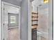 This bathroom features a vanity and a shower-tub combination with unique wood shelving at 4601 Sw Reynosa Sw Dr, Winter Haven, FL 33880