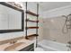 This bathroom features a vanity and a shower-tub combination with unique wood shelving at 4601 Sw Reynosa Sw Dr, Winter Haven, FL 33880