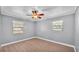 This bedroom features modern wood-look floors, two windows and a ceiling fan at 4601 Sw Reynosa Sw Dr, Winter Haven, FL 33880