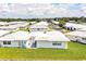 An aerial view of a community with white roofs and green lawns at 474 Cameo Dr, Lakeland, FL 33803