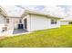 Backyard featuring a white building with a covered patio and lush green lawn at 474 Cameo Dr, Lakeland, FL 33803