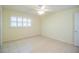 Bedroom with tile flooring, ceiling fan, and large window with plantation shutters at 474 Cameo Dr, Lakeland, FL 33803