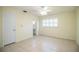 Bedroom with tile flooring, ceiling fan, and large window with plantation shutters at 474 Cameo Dr, Lakeland, FL 33803