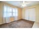 Bedroom with carpet, ceiling fan, closet and shuttered window at 474 Cameo Dr, Lakeland, FL 33803