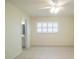 Bedroom with tile flooring, ceiling fan, and large window with plantation shutters at 474 Cameo Dr, Lakeland, FL 33803