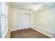 Bedroom with neutral carpet, ceiling fan, and a window with white shutters at 474 Cameo Dr, Lakeland, FL 33803