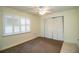 Bedroom with neutral carpet, ceiling fan, and a window with white shutters at 474 Cameo Dr, Lakeland, FL 33803