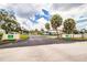 Entrance to The Villas community with manicured landscaping at 474 Cameo Dr, Lakeland, FL 33803