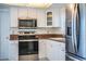 Updated kitchen featuring stainless steel appliances, stone countertops, and white cabinetry at 474 Cameo Dr, Lakeland, FL 33803