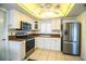 Well-lit kitchen features stainless steel appliances, white cabinetry, and a unique ceiling light fixture at 474 Cameo Dr, Lakeland, FL 33803