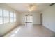 Bright and spacious living room with neutral tile flooring, ceiling fan, plantation shutters, and an adjacent kitchen at 474 Cameo Dr, Lakeland, FL 33803