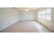 Bright living room featuring tile flooring, modern ceiling fan, and plantation shutters at 474 Cameo Dr, Lakeland, FL 33803