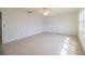 Bright living room featuring tile flooring, modern ceiling fan, and plantation shutters at 474 Cameo Dr, Lakeland, FL 33803