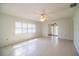 Bright living room featuring tile flooring, modern ceiling fan, and plantation shutters at 474 Cameo Dr, Lakeland, FL 33803