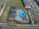 Aerial shot of a stunning pool area, playground, and community buildings, surrounded by lush landscaping at 5002 Rain Shadow Dr, St Cloud, FL 34772