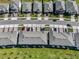 Aerial view of new townhomes, highlighting rooftops, driveways, and landscaping in a suburban setting at 5002 Rain Shadow Dr, St Cloud, FL 34772