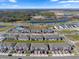 Aerial view of a neighborhood with a community pool, townhomes, and a scenic lake on a clear day at 5002 Rain Shadow Dr, St Cloud, FL 34772