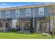 Townhome backyard featuring a screened-in patio and a well-maintained lawn at 5002 Rain Shadow Dr, St Cloud, FL 34772