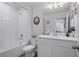 Bathroom features white cabinets and modern fixtures, complete with tub and shower at 5002 Rain Shadow Dr, St Cloud, FL 34772