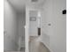 Bright hallway showcasing the upper level with white walls and trim leading to various rooms in the house at 5002 Rain Shadow Dr, St Cloud, FL 34772