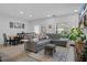 Comfortable living room with a gray sofa, decorative accents, and a view of the dining area at 5002 Rain Shadow Dr, St Cloud, FL 34772