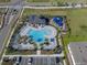 Aerial photo of community pool with lounging area, playground, parking, and lush landscaping at 5002 Rain Shadow Dr, St Cloud, FL 34772