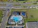 Aerial shot showcasing a community pool, playground, and parking, surrounded by green spaces at 5002 Rain Shadow Dr, St Cloud, FL 34772