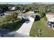 Aerial view of a home with long driveway and multiple storage sheds, offering a comprehensive look at the property at 5121 Idlewood Ln, Lakeland, FL 33811