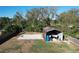 Aerial view of the property showcasing sheds, and basketball court, highlighting the lot's recreational amenities at 5121 Idlewood Ln, Lakeland, FL 33811