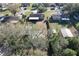 Aerial shot of a home in residential neighborhood with sheds and a partially covered patio, providing a sense of community at 5121 Idlewood Ln, Lakeland, FL 33811