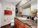 Cozy bathroom features a decorative mirror, modern vanity and granite countertop and a shower-tub combo at 5121 Idlewood Ln, Lakeland, FL 33811