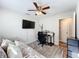 Bright bedroom featuring a ceiling fan, mounted TV, desk and chair on dark wood-look floors at 5121 Idlewood Ln, Lakeland, FL 33811