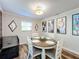 Dining room with a round table, four chairs, light fixture, and Gathering pictures on the wall at 5121 Idlewood Ln, Lakeland, FL 33811