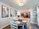 Dining room with a round table, four chairs and Gathering pictures on the wall connecting to kitchen at 5121 Idlewood Ln, Lakeland, FL 33811