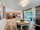 Dining room with a round table, four chairs, light fixture, and an opening to kitchen at 5121 Idlewood Ln, Lakeland, FL 33811