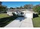 Aerial view of a charming single-story home with attached garage, highlighting its appealing facade and landscaping at 5121 Idlewood Ln, Lakeland, FL 33811