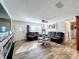 Cozy living room featuring stylish wood-look flooring, a ceiling fan, and ample natural light at 5121 Idlewood Ln, Lakeland, FL 33811