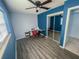 Bedroom with stylish wood-look floors, a modern ceiling fan, and a mirrored closet at 526 Hampton Ave, Lakeland, FL 33801