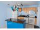 The bright kitchen features an island, updated appliances, light wood cabinets, and light blue walls at 526 Hampton Ave, Lakeland, FL 33801