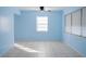 A spacious living room with tiled flooring, light blue walls, and bright natural light at 526 Hampton Ave, Lakeland, FL 33801