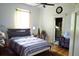 Cozy bedroom featuring a ceiling fan, window, and en-suite bathroom at 5626 Sawyer Rd, Lakeland, FL 33810