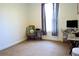 Bright bedroom featuring a chair, desk and monitor next to a window with decorative curtains at 5626 Sawyer Rd, Lakeland, FL 33810