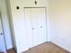 Bedroom closet with folding doors and neutral carpeting at 5626 Sawyer Rd, Lakeland, FL 33810