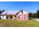 Charming house with a metal roof, brick section, and a cozy front porch at 5626 Sawyer Rd, Lakeland, FL 33810