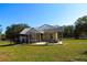 View of home exterior featuring a screened-in porch and a fenced yard on a sunny day at 5626 Sawyer Rd, Lakeland, FL 33810