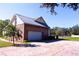 A view of the side of the house, showing the two-car garage and ample parking space at 5626 Sawyer Rd, Lakeland, FL 33810